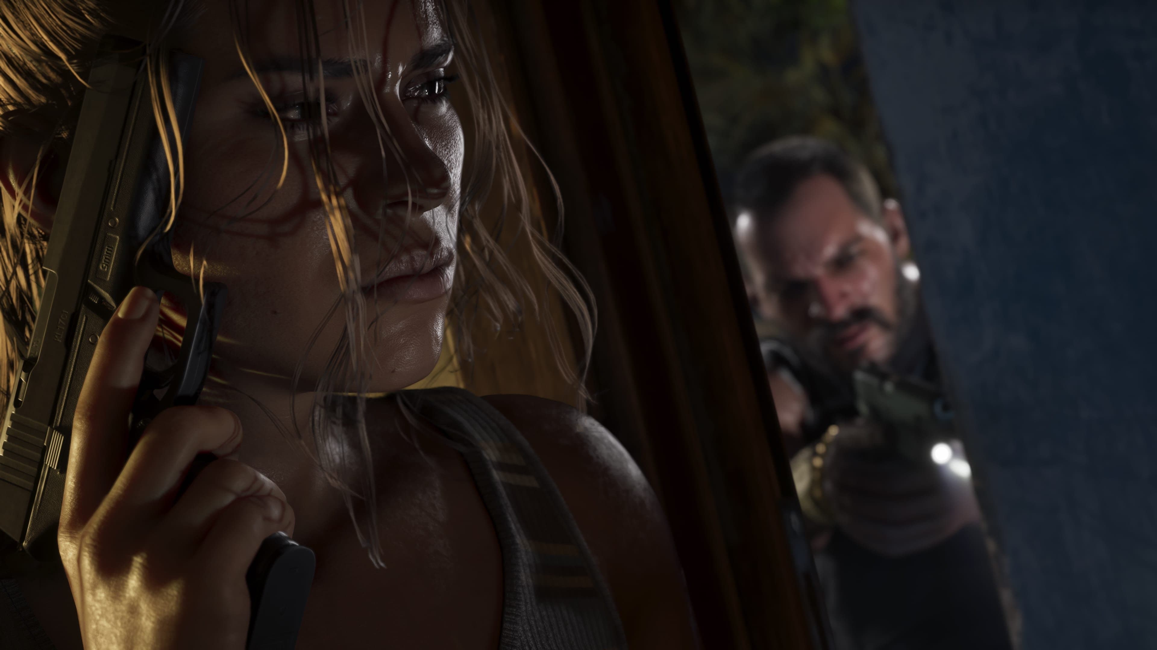 Lucia holding an unidentified 9mm handgun.