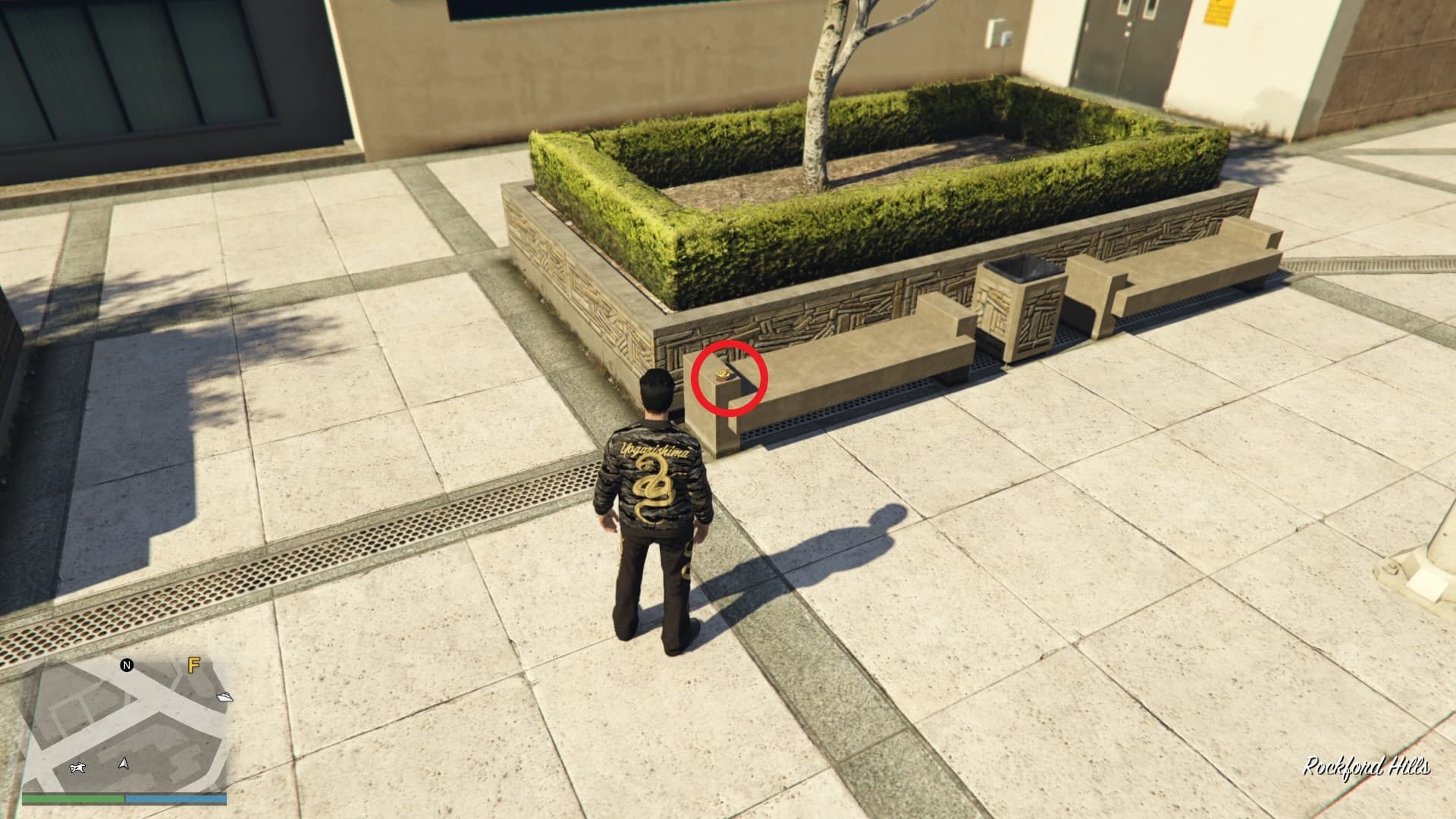 The Yuanbao is on a solid bench by the grass patch decoration.