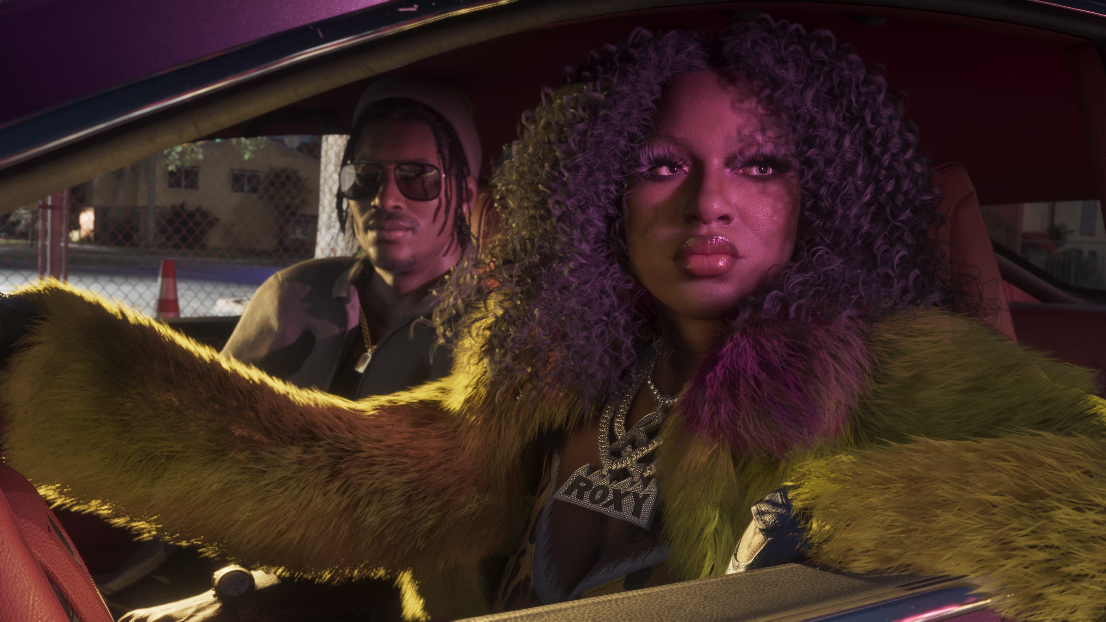 Roxy with Dre'Quan Priest in the passenger seat of an unidentified vehicle.