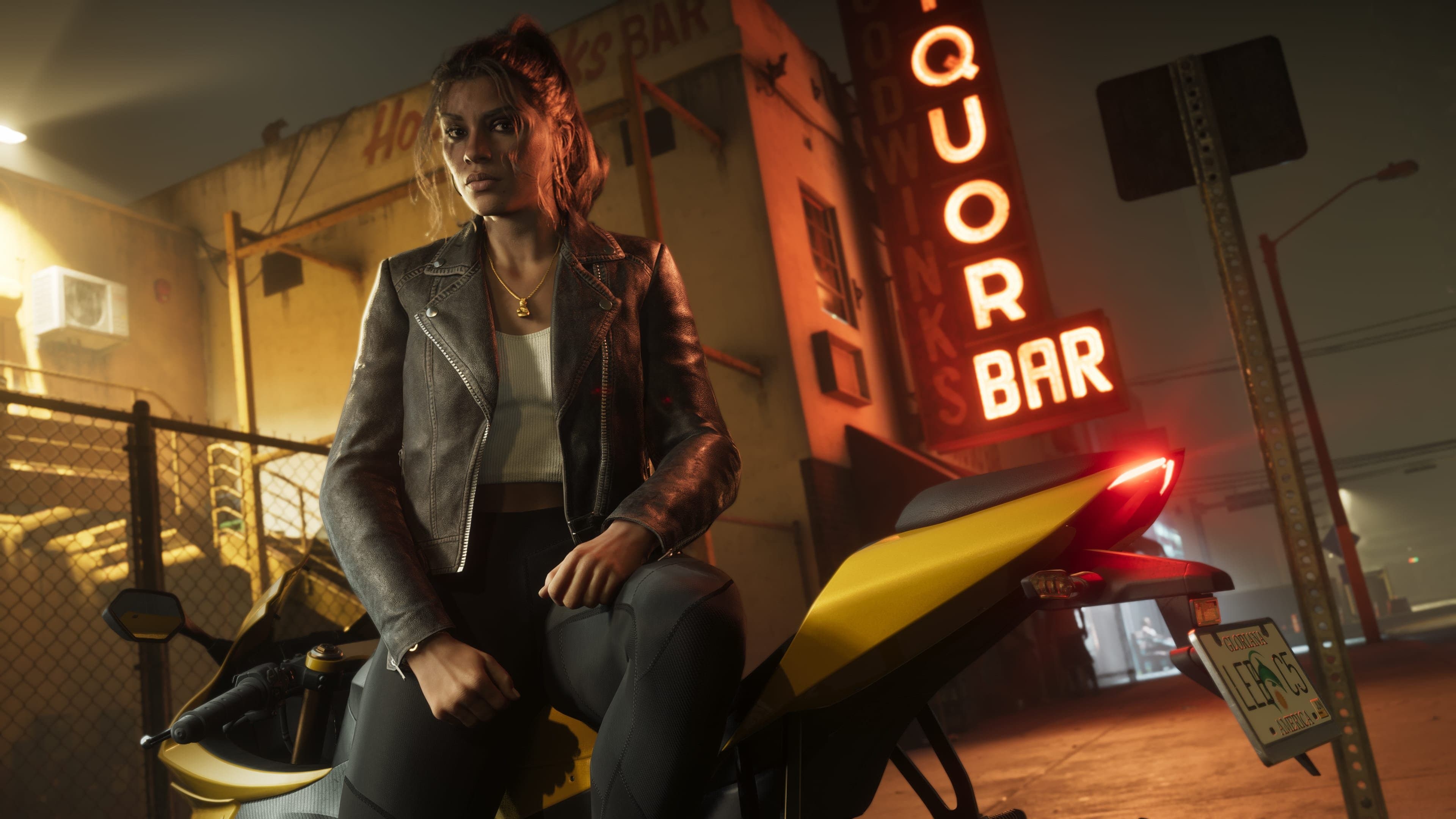 Lucia Caminos sitting on a yellow unidentified motorcycle.