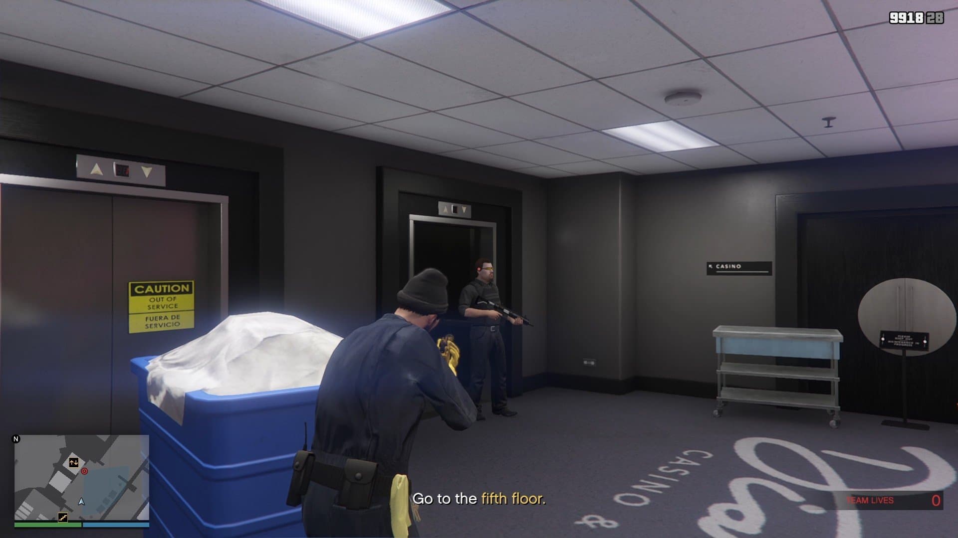 Security guard by the elevator on the ground floor.